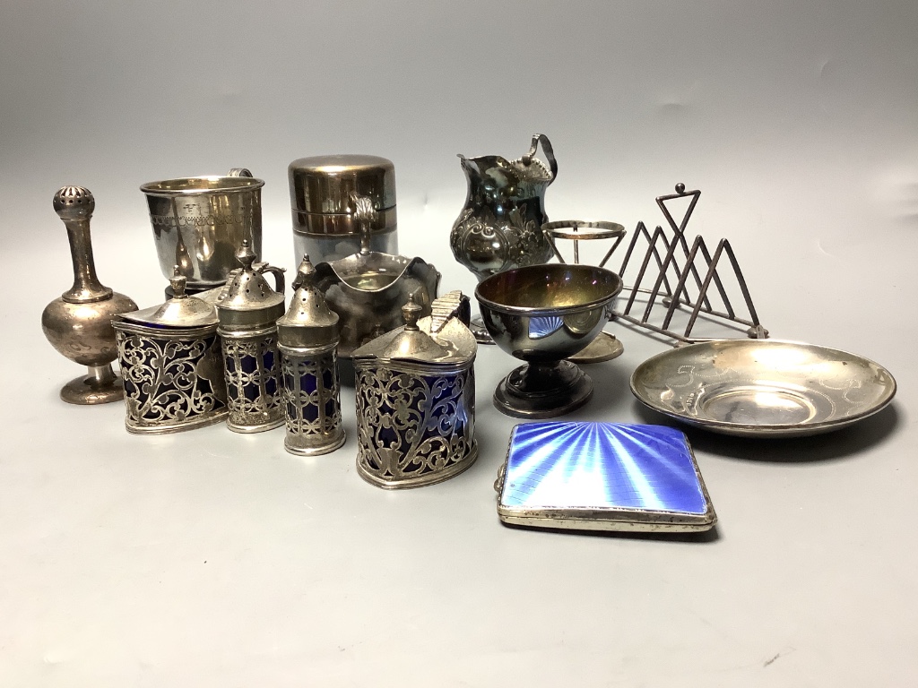 A group of 18th century and later silver, including a George III Newcastle sauceboat, by John Langlands and cream jug, later condiment set, Victorian toastrack, trophy, salts bottle, salt, rosewater sprinkler etc. some a